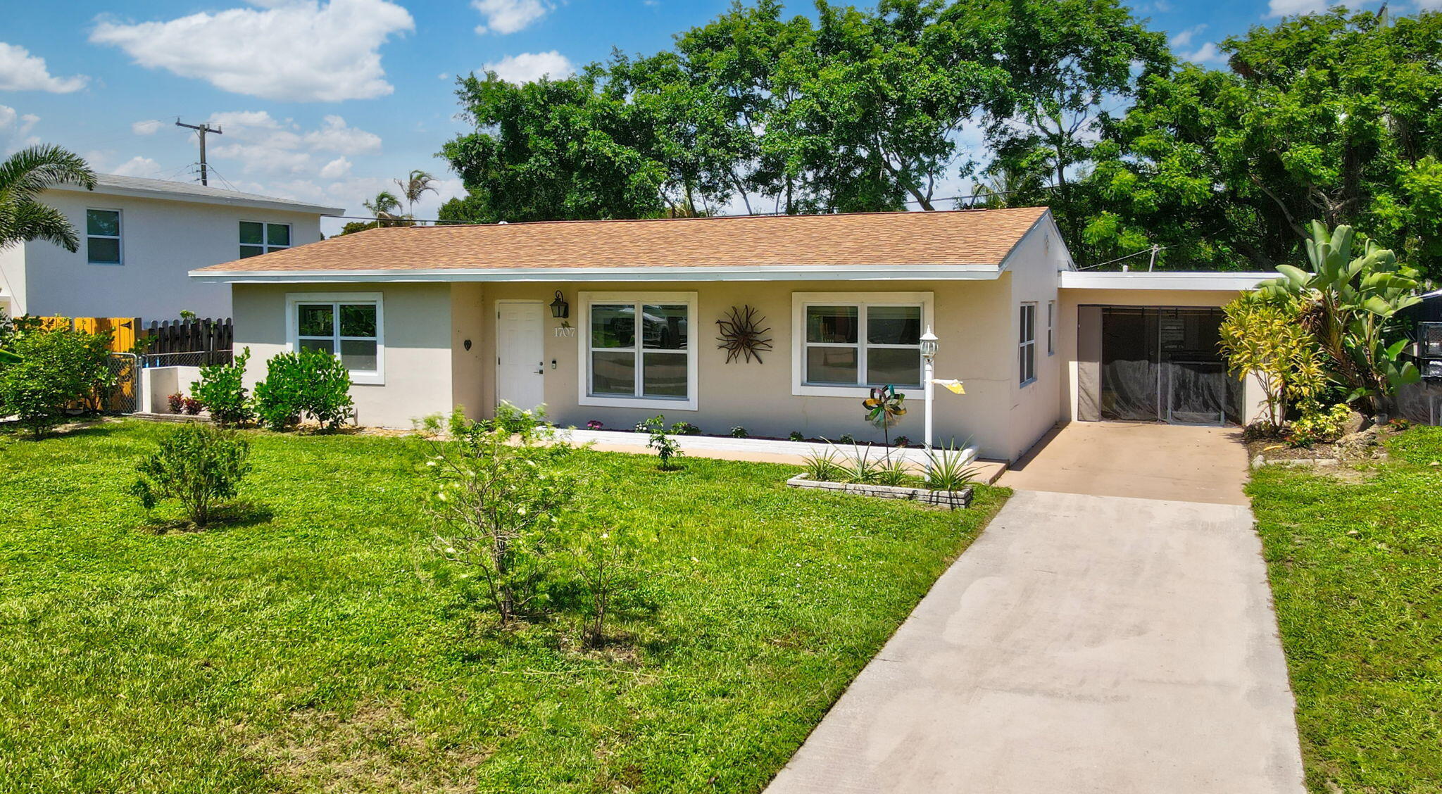 1707 High Ridge Road Lake Worth, FL 33461 - Photo 2 of 36 a view of a house with garden