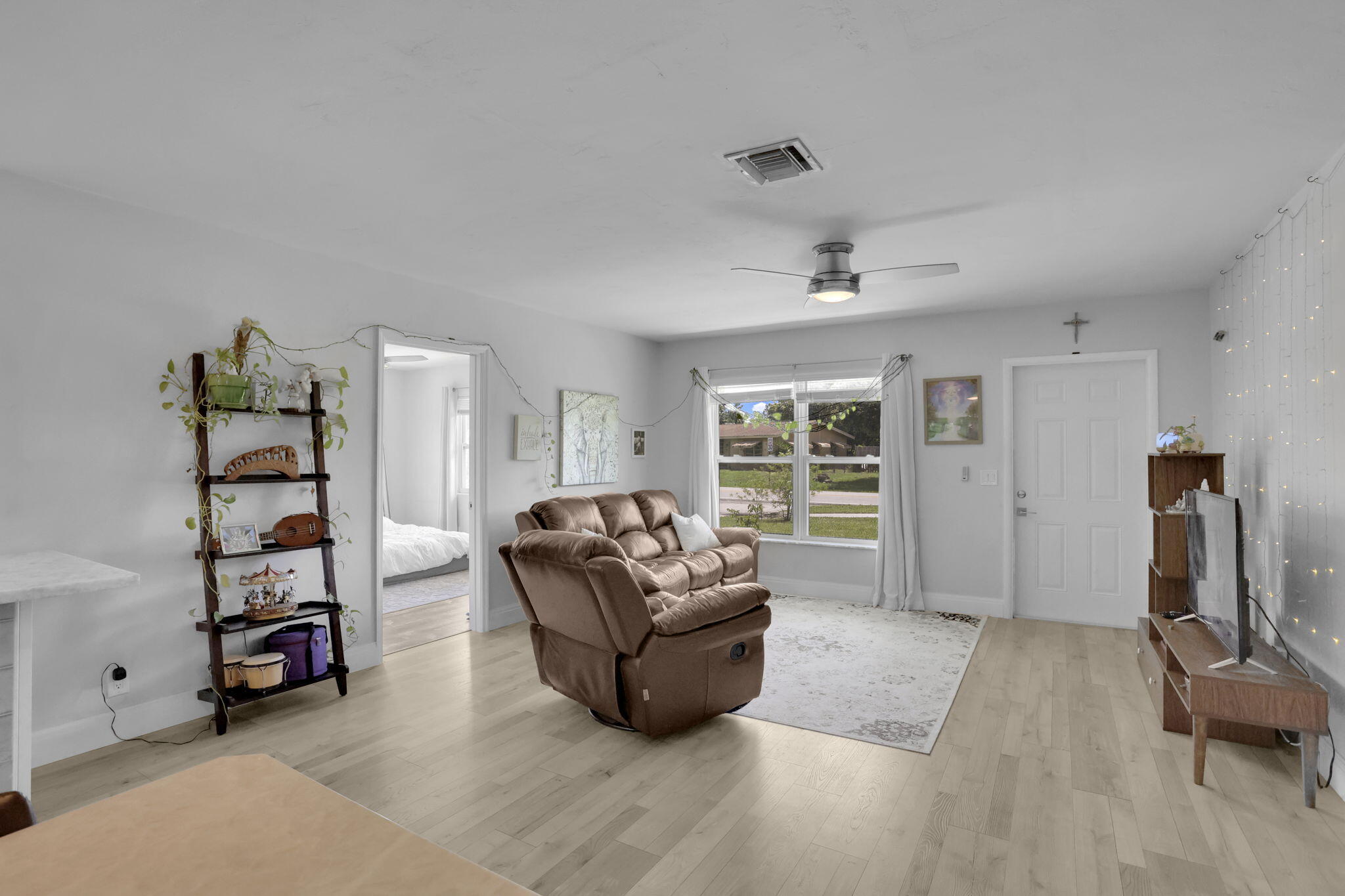 1707 High Ridge Road Lake Worth, FL 33461 - Photo 7 of 36 a living room with furniture and a window