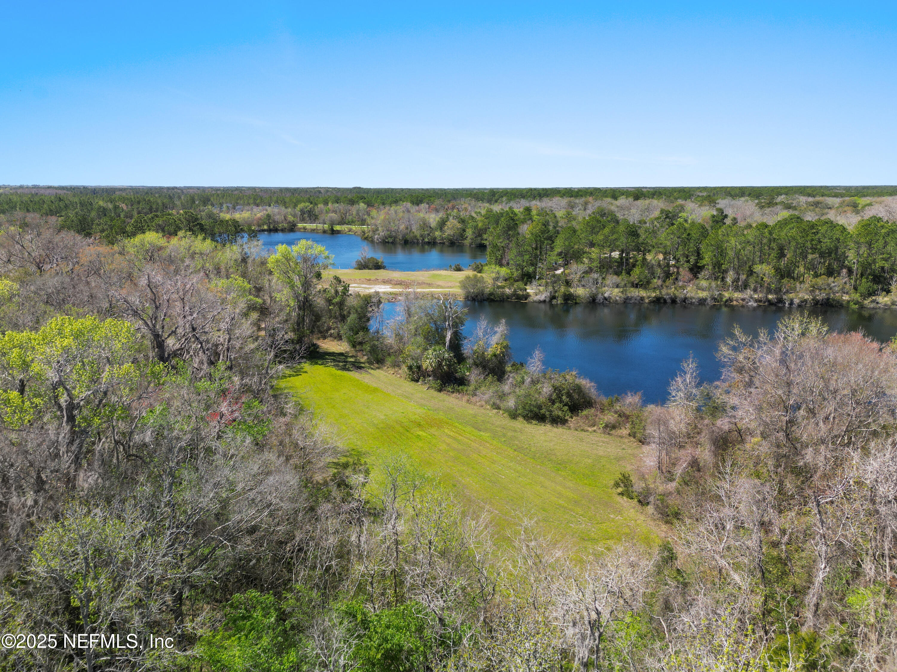 0 Deer Run Road St. Augustine, FL 32084 - Photo 3 of 12 a view of a lake with houses in the back