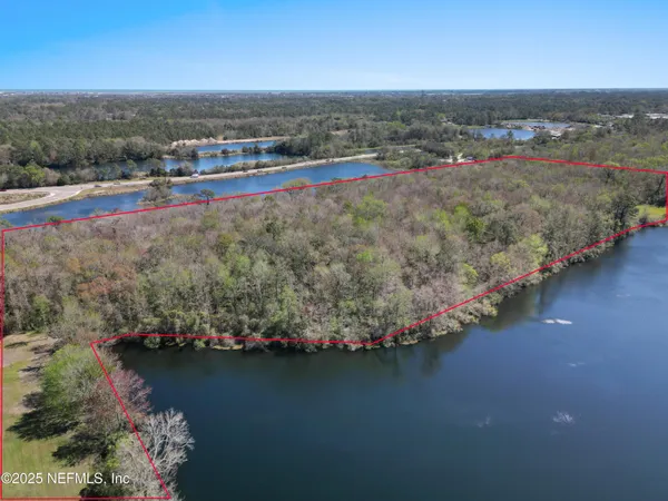 an aerial view of a houses with a yard