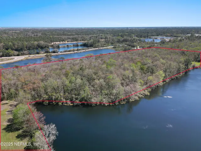 an aerial view of a houses with a yard