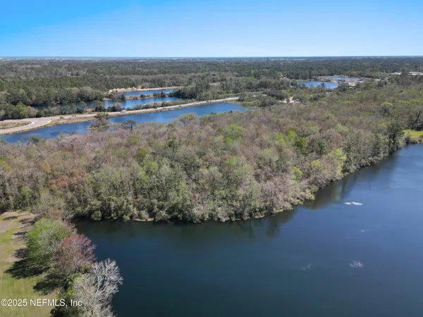 an aerial view of a houses with ocean view