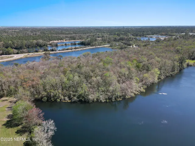 an aerial view of a houses with ocean view