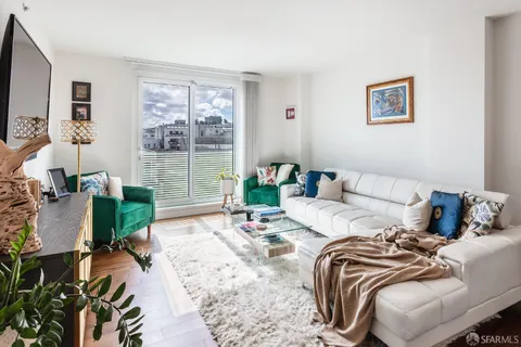a living room with furniture large window and a flat screen tv