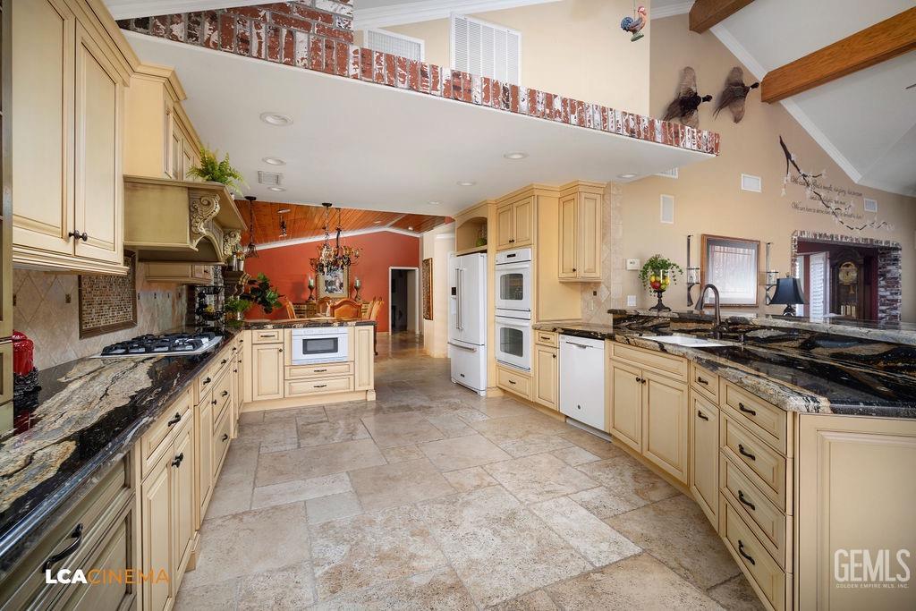 Undisclosed Address Shafter, CA 93263 - Photo 12 of 34 a large white kitchen with stainless steel appliances and a stove