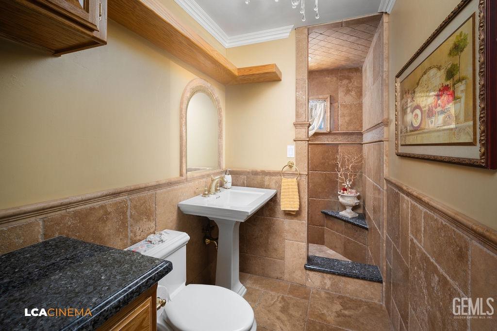 Undisclosed Address Shafter, CA 93263 - Photo 16 of 34 a bathroom with a sink a toilet and mirror