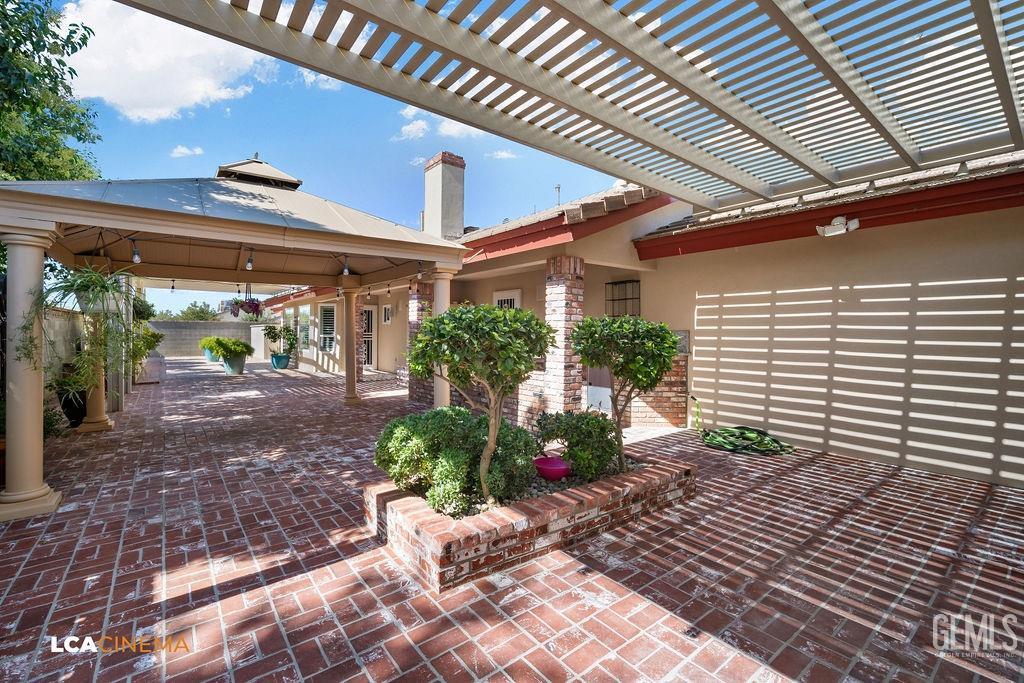 Undisclosed Address Shafter, CA 93263 - Photo 25 of 34 a view of a patio with table and chairs and potted plants