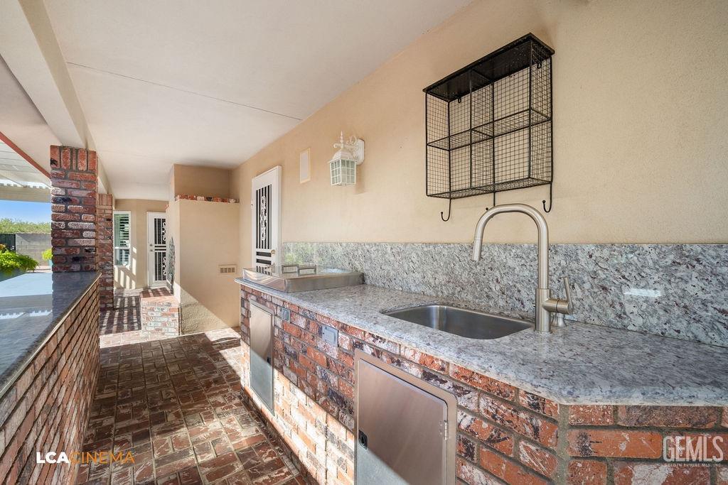 Undisclosed Address Shafter, CA 93263 - Photo 28 of 34 a kitchen with a sink and a refrigerator