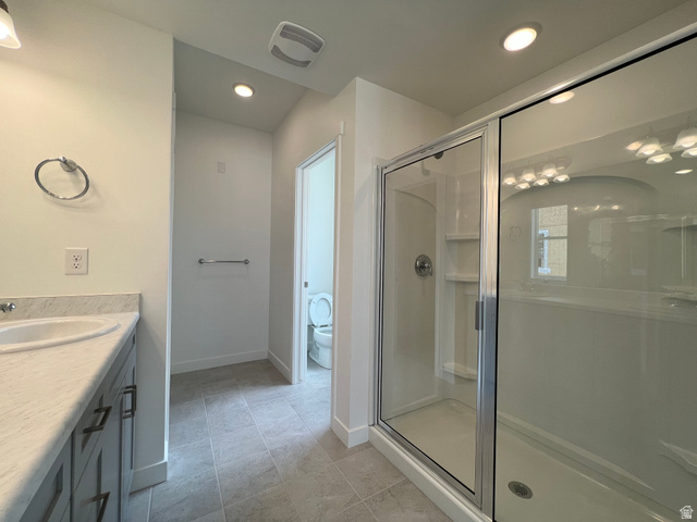 717 West W Coho Lane South, Unit 2F302 Midvale, UT 84047 - Photo 19 of 22 Bathroom featuring a single vanity with stone-finish countertop, undermount sink, and dark cabinetry with modern hardware
