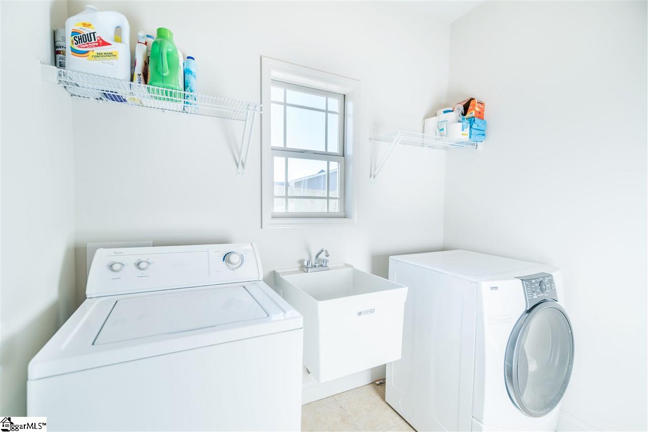 26 Caperton Way Greer, SC 29651 - Photo 14 of 23 Spacious Laundry room with convenient sink, beautiful window for natural light and a closet.
