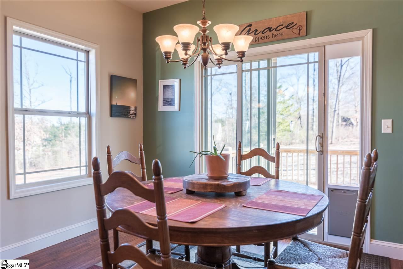 26 Caperton Way Greer, SC 29651 - Photo 7 of 23 Breakfast room overlooking yard with distant mountain views leading out to back deck.