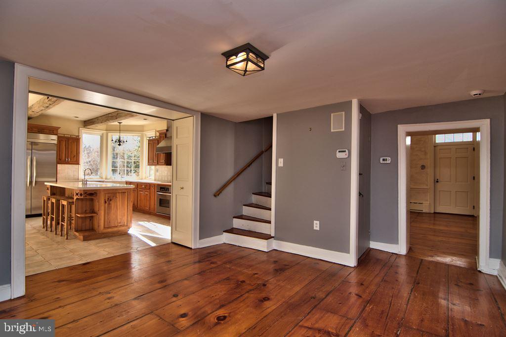 3055 Haupts Bridge Road Riegelsville, PA 18077 - Photo 12 of 65 Sitting Rm w view of pie wedge stairs, & kitchen
