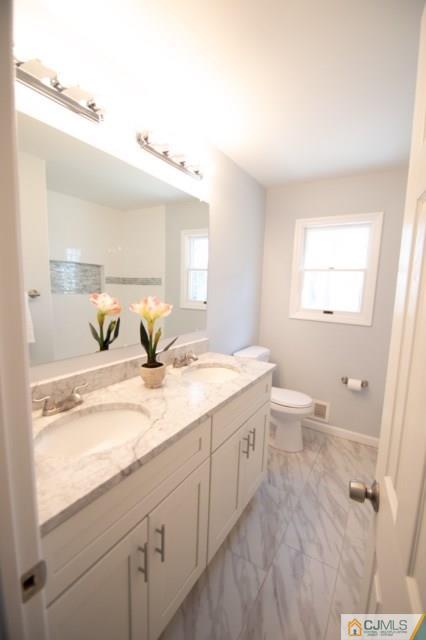 23 Ferris Road Edison, NJ 08817 - Photo 15 of 21 a bathroom with a granite countertop sink and a mirror