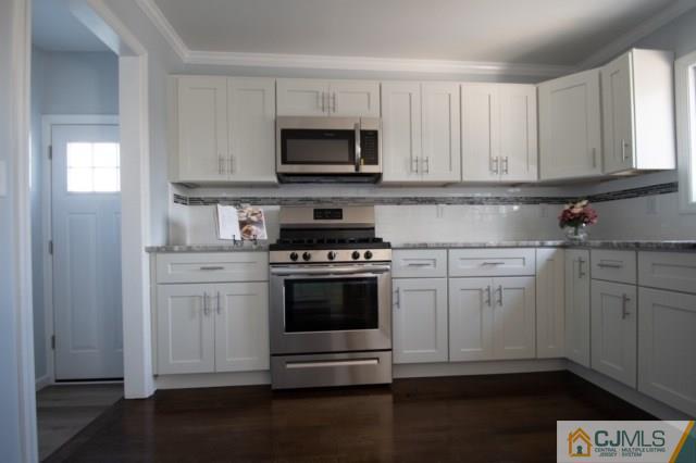 23 Ferris Road Edison, NJ 08817 - Photo 8 of 21 a kitchen with cabinets stainless steel appliances and wooden floor