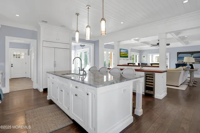 a kitchen with sink stove and wooden floor