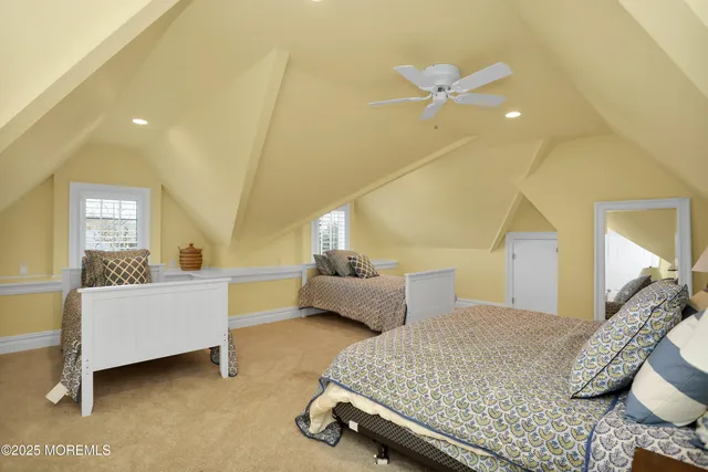 a living room with furniture kitchen view and a flat screen tv