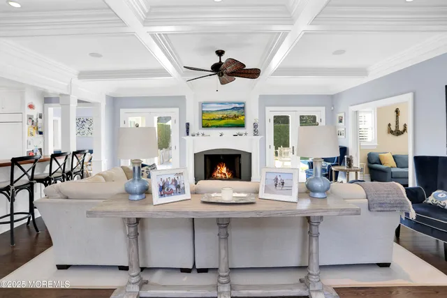 a living room with fireplace furniture and a wooden floor