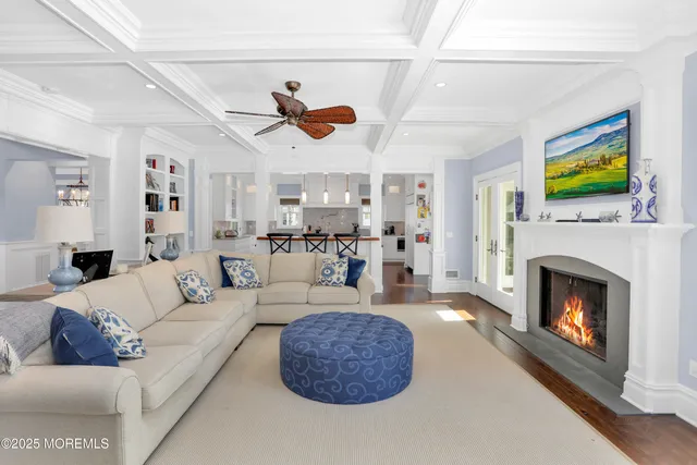 a living room with furniture kitchen view and a fireplace