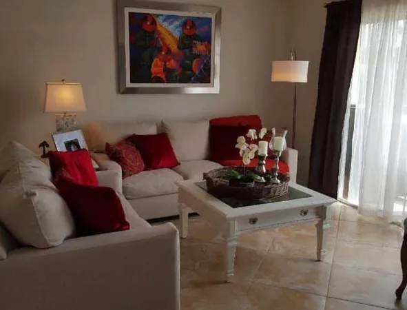 a living room with furniture and a mirror