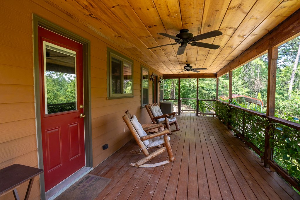 495 Midway Creek Road Murphy, NC 28906 - Photo 4 of 38 a roof deck with table and chairs and wooden floor