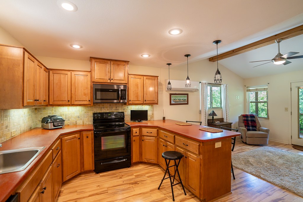 495 Midway Creek Road Murphy, NC 28906 - Photo 8 of 38 a kitchen with a sink a counter top space stainless steel appliances and cabinets