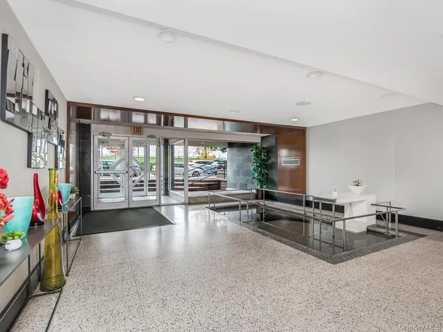 a lobby with furniture and floor to ceiling window