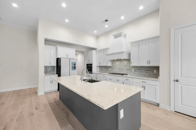 an open kitchen with granite countertop a sink and a stove