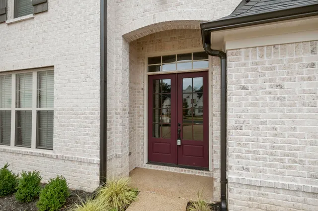 a front view of a house with a glass windows