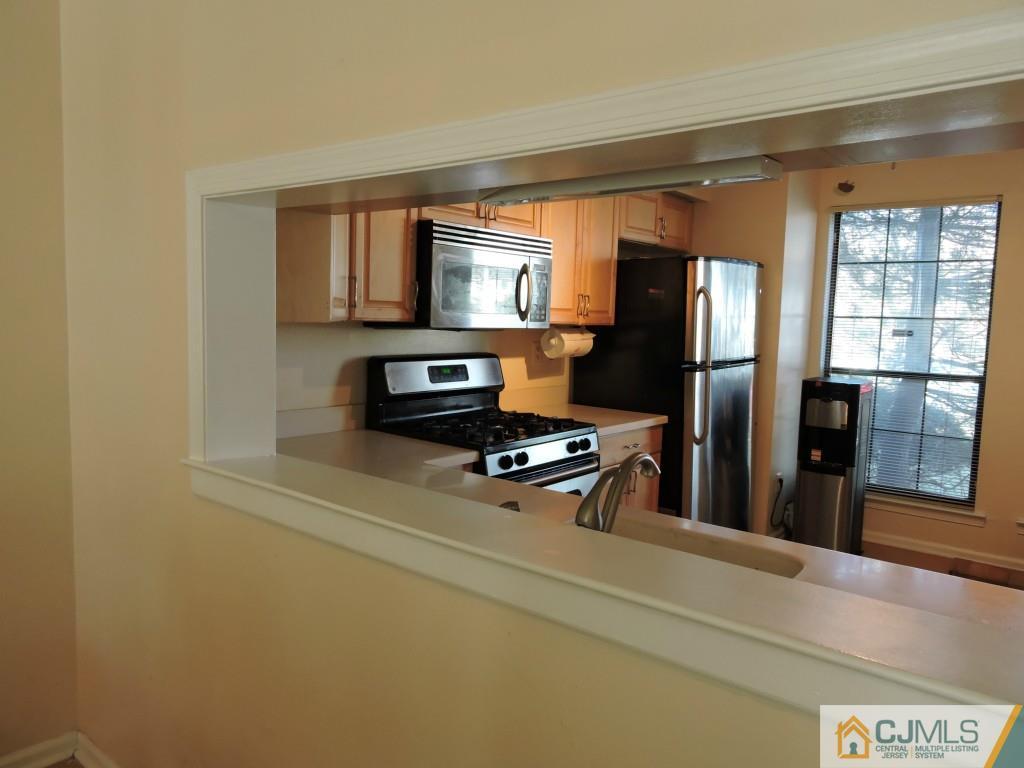 606 Timber Oaks Road Edison, NJ 08820 - Photo 8 of 14 a kitchen with stainless steel appliances a refrigerator and a stove top oven