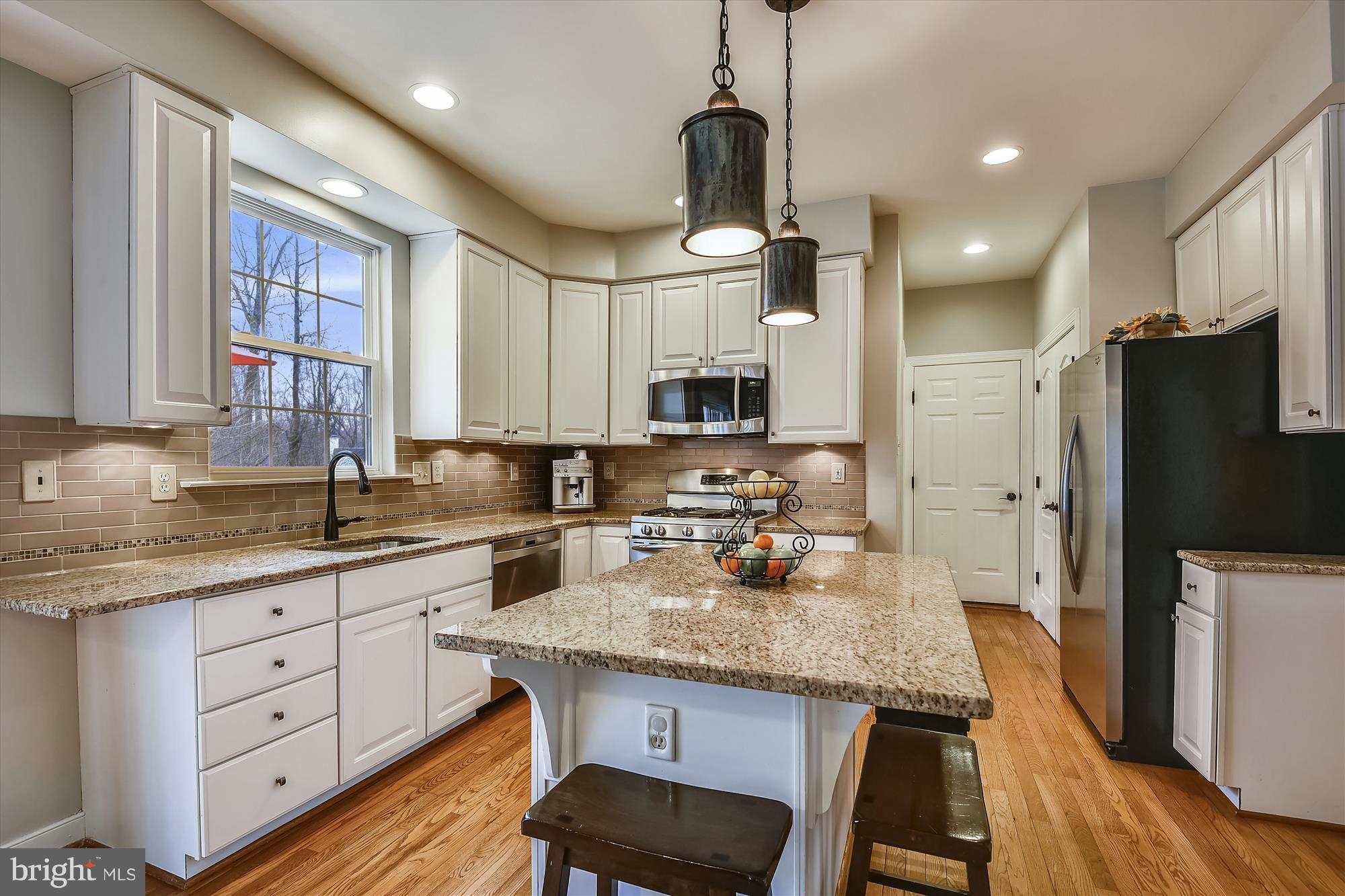 484 Stratford Road Fallston, MD 21047 - Photo 13 of 44 a kitchen with granite countertop a center island stainless steel appliances cabinets and wooden floor