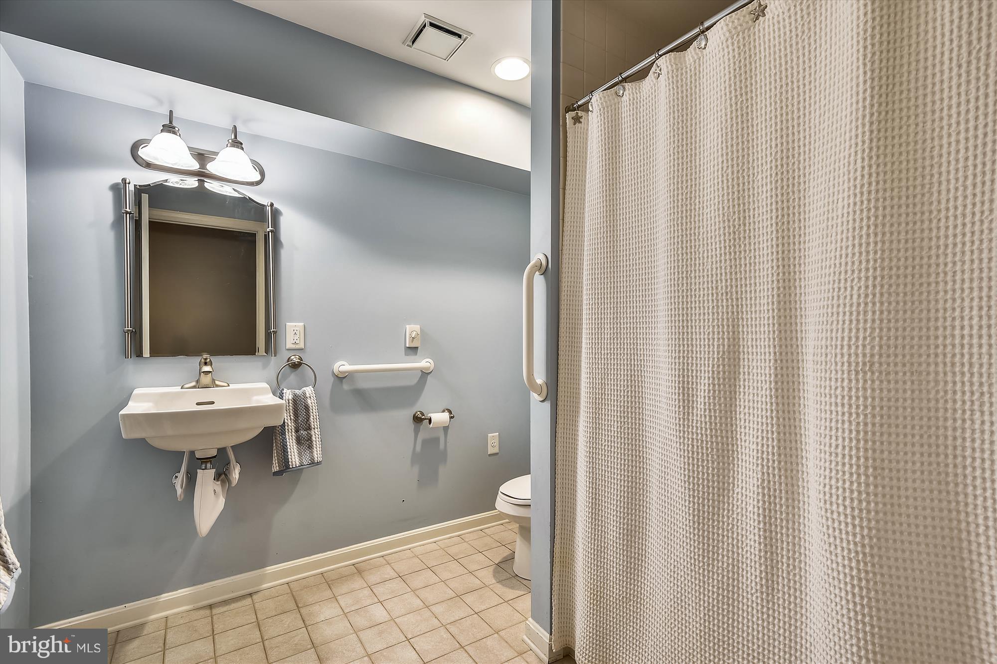 484 Stratford Road Fallston, MD 21047 - Photo 39 of 44 a bathroom with a sink a toilet and shower curtain