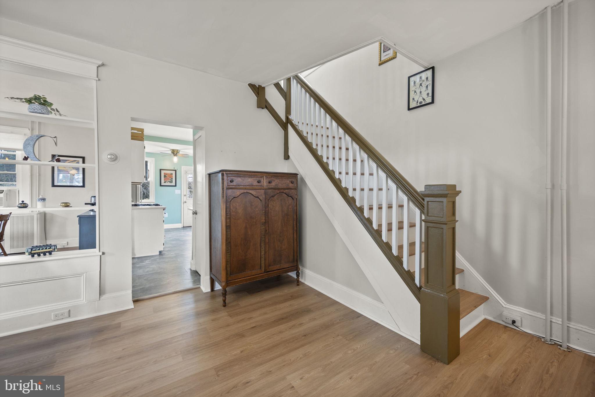 4 Elinor Avenue Baltimore, MD 21236 - Photo 12 of 47 a view of a livingroom with wooden floor and stairs