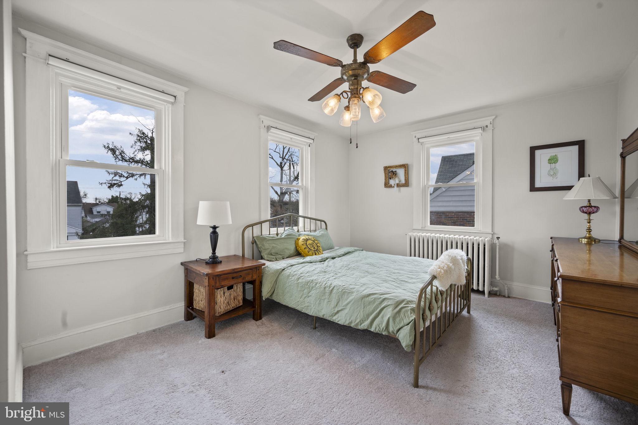 4 Elinor Avenue Baltimore, MD 21236 - Photo 13 of 47 a bedroom with a bed and a chandelier