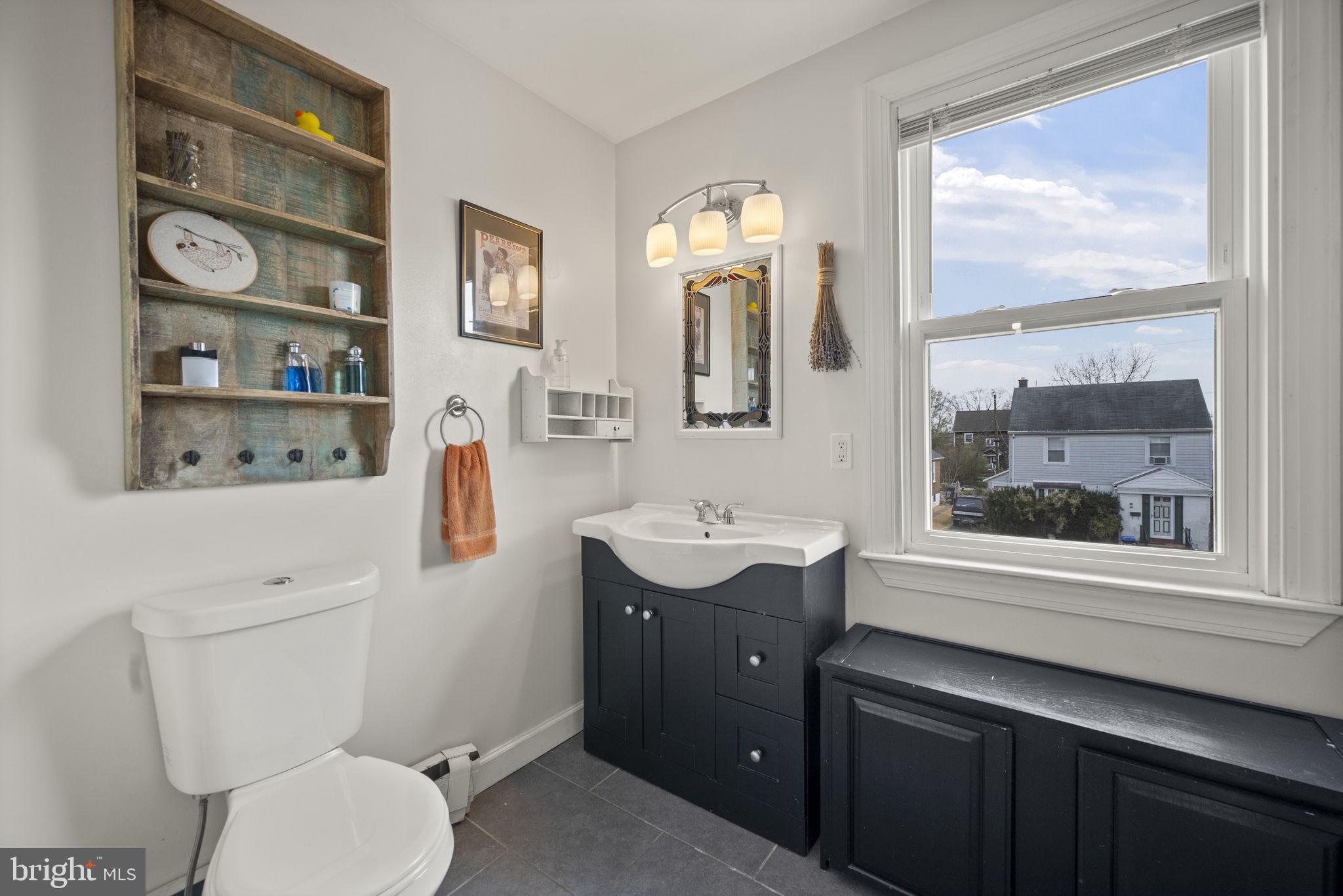 4 Elinor Avenue Baltimore, MD 21236 - Photo 16 of 47 a bathroom with a toilet a sink and a large mirror