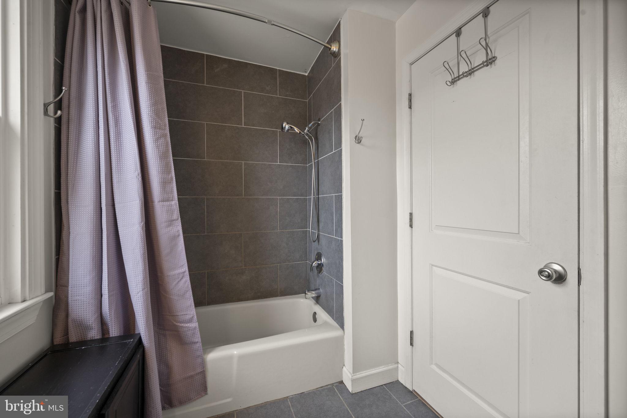 4 Elinor Avenue Baltimore, MD 21236 - Photo 17 of 47 a bathroom with a bathtub and a shower