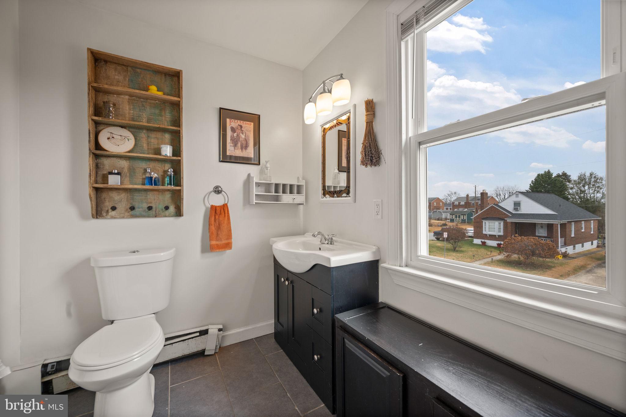 4 Elinor Avenue Baltimore, MD 21236 - Photo 18 of 47 a bathroom with a toilet sink and mirror
