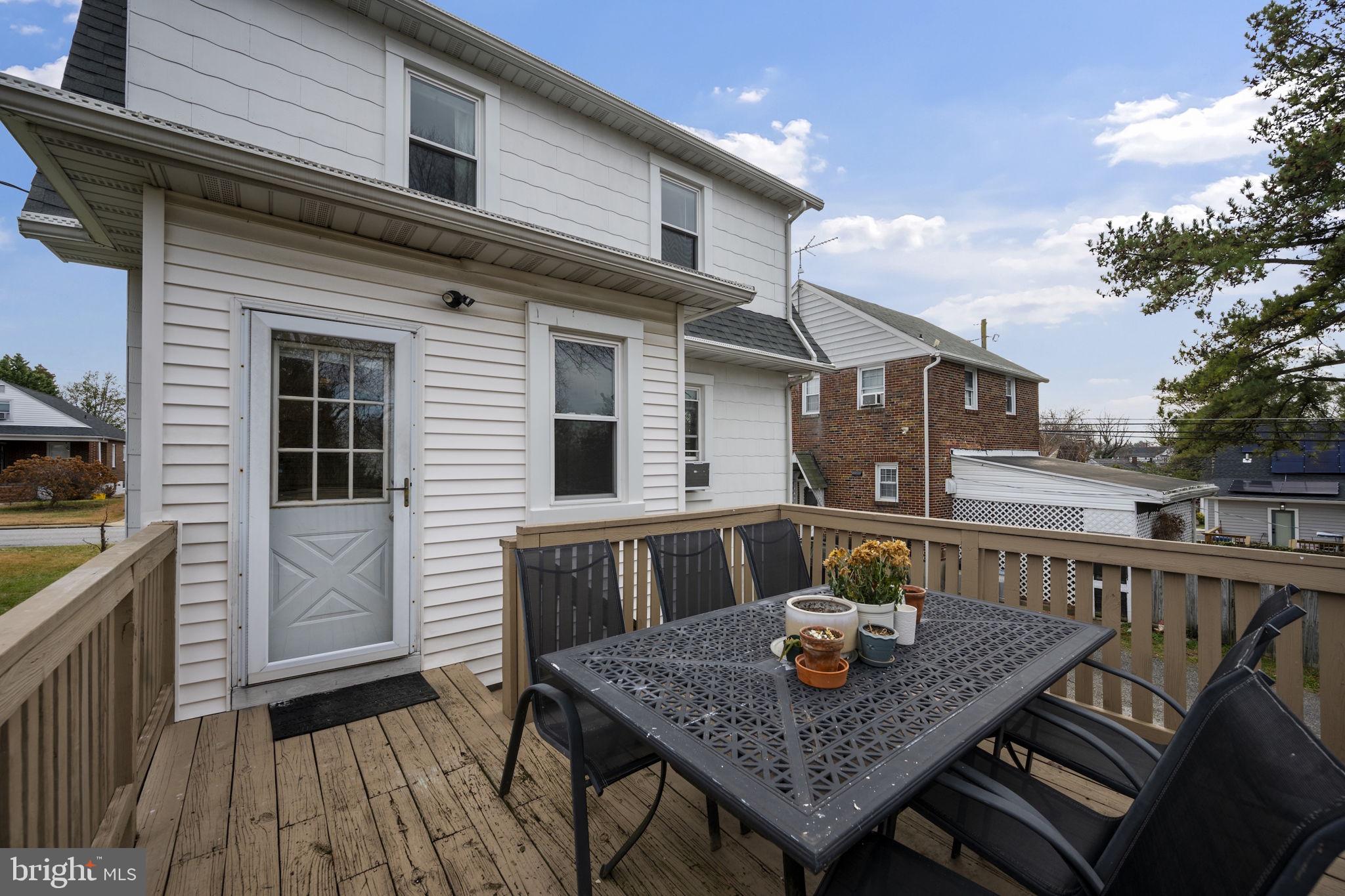 4 Elinor Avenue Baltimore, MD 21236 - Photo 37 of 47 a table and chairs in front of a house