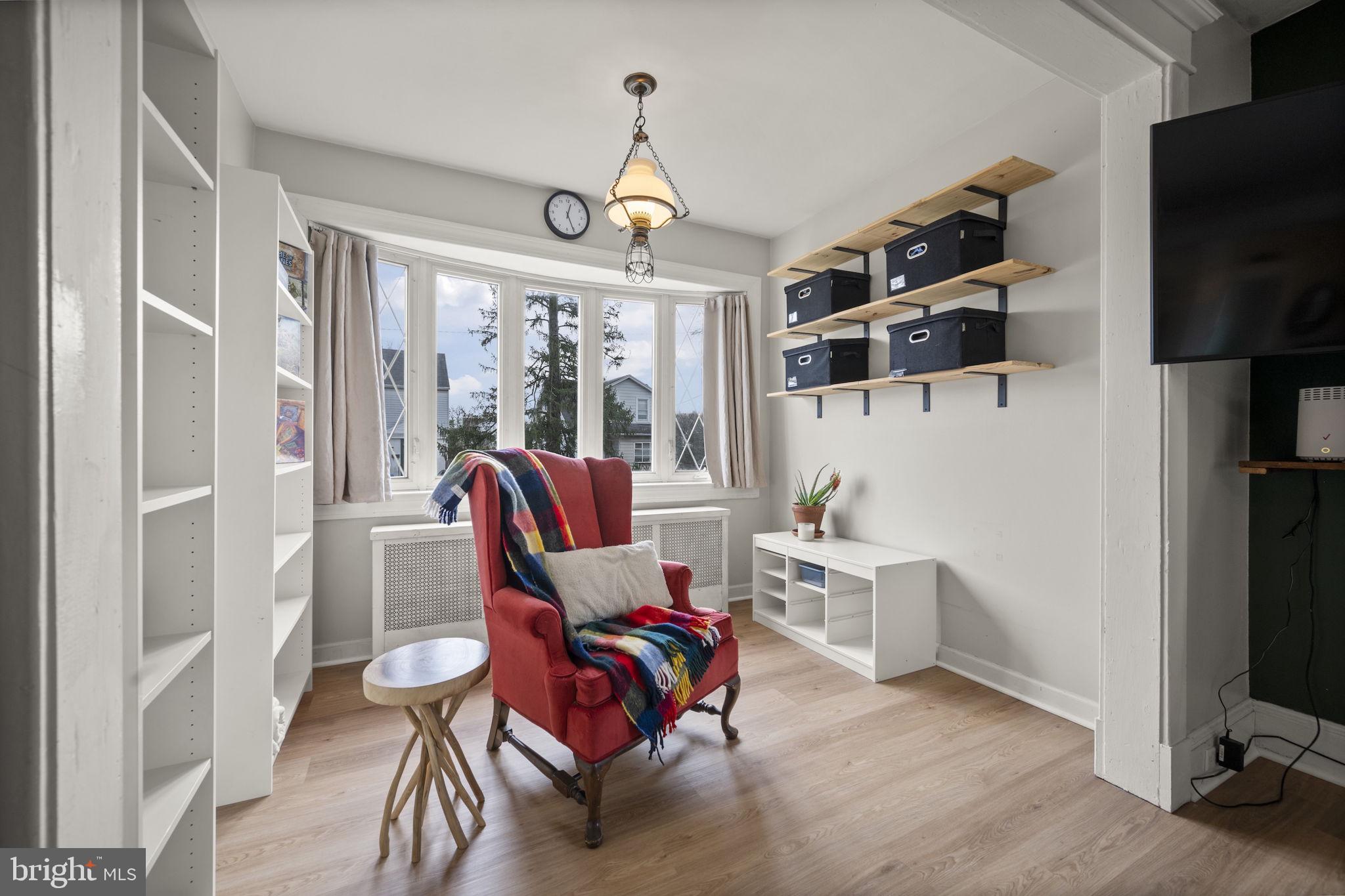 4 Elinor Avenue Baltimore, MD 21236 - Photo 5 of 47 a living room with furniture a flat screen tv and a floor to ceiling window