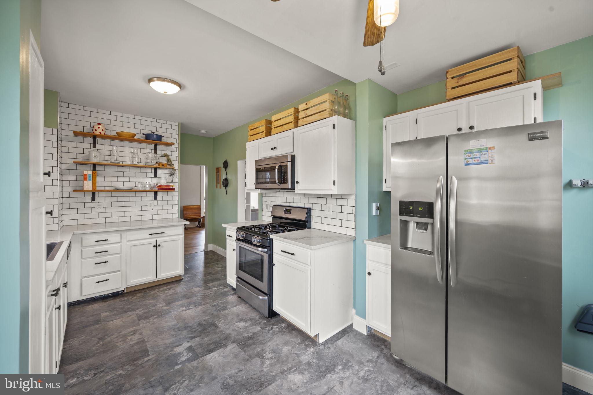 4 Elinor Avenue Baltimore, MD 21236 - Photo 7 of 47 a kitchen with white cabinets and stainless steel appliances