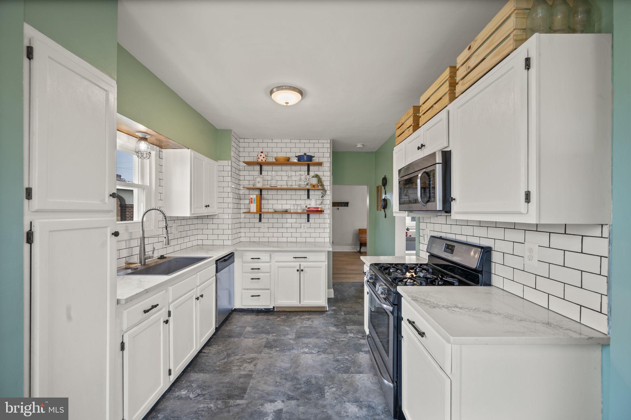 4 Elinor Avenue Baltimore, MD 21236 - Photo 8 of 47 a kitchen with white cabinets and appliances