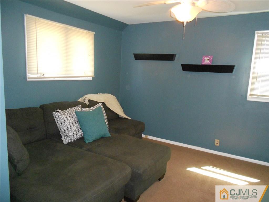 5 Kendall Road East Brunswick, NJ 08816 - Photo 2 of 12 a bed sitting in a bedroom next to a window