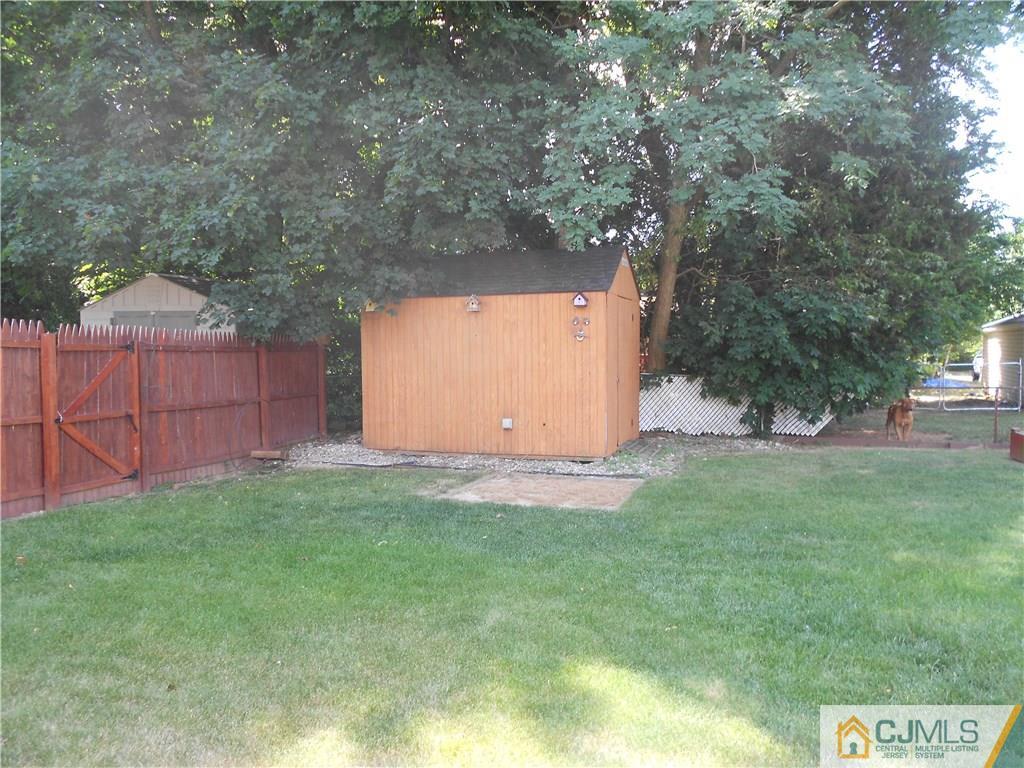 5 Kendall Road East Brunswick, NJ 08816 - Photo 12 of 12 a backyard of a house with lots of green space