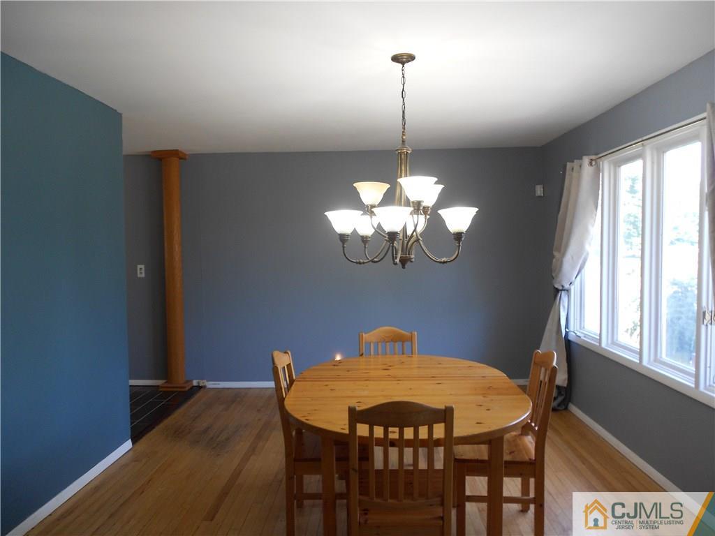 5 Kendall Road East Brunswick, NJ 08816 - Photo 4 of 12 a view of a dining room with furniture a chandelier and wooden floor