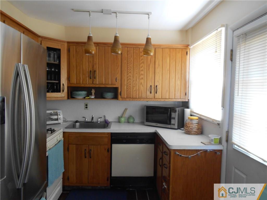 5 Kendall Road East Brunswick, NJ 08816 - Photo 5 of 12 a kitchen with a sink a refrigerator and a stove