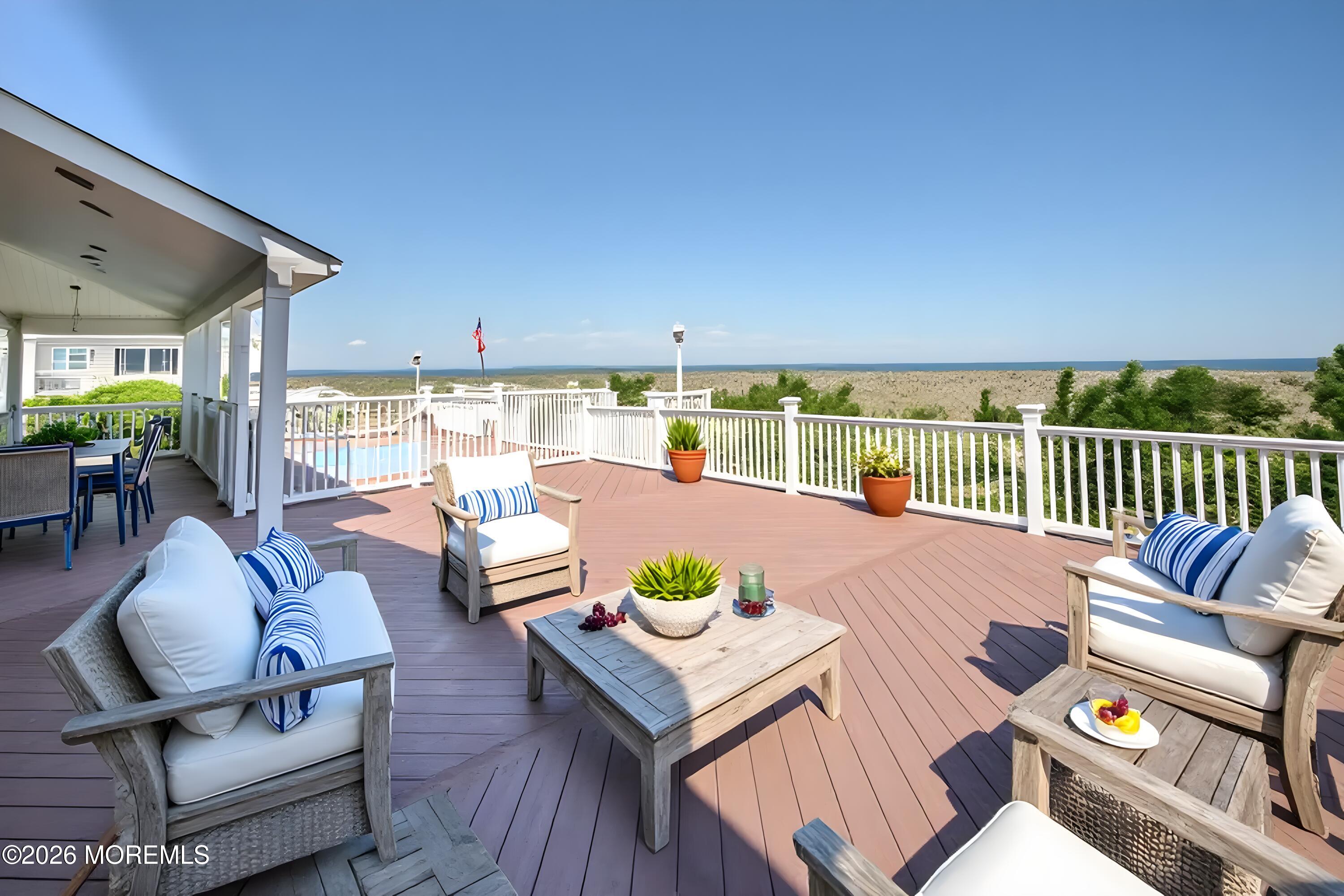 805 Front Street Union Beach, NJ 07735 - Photo 39 of 65 a view of a patio with couches chairs dining table and chairs