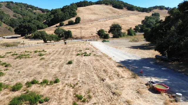 a view of a yard with snow on the road