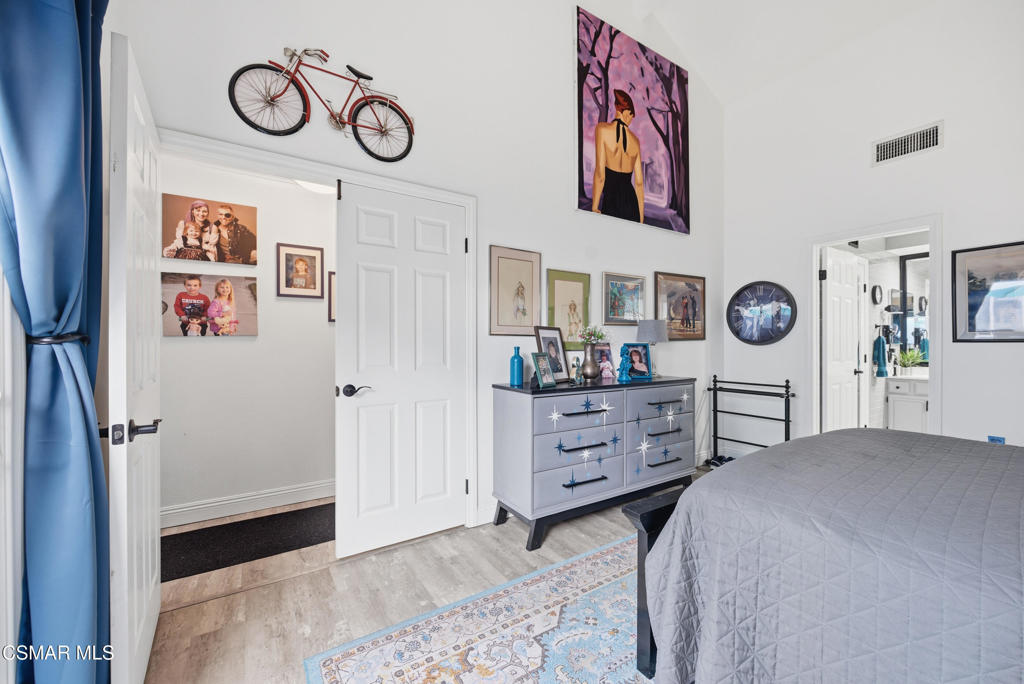 2497 Orangewood Place Simi Valley, CA 93065 - Photo 19 of 42 a bedroom with a bed and a chandelier