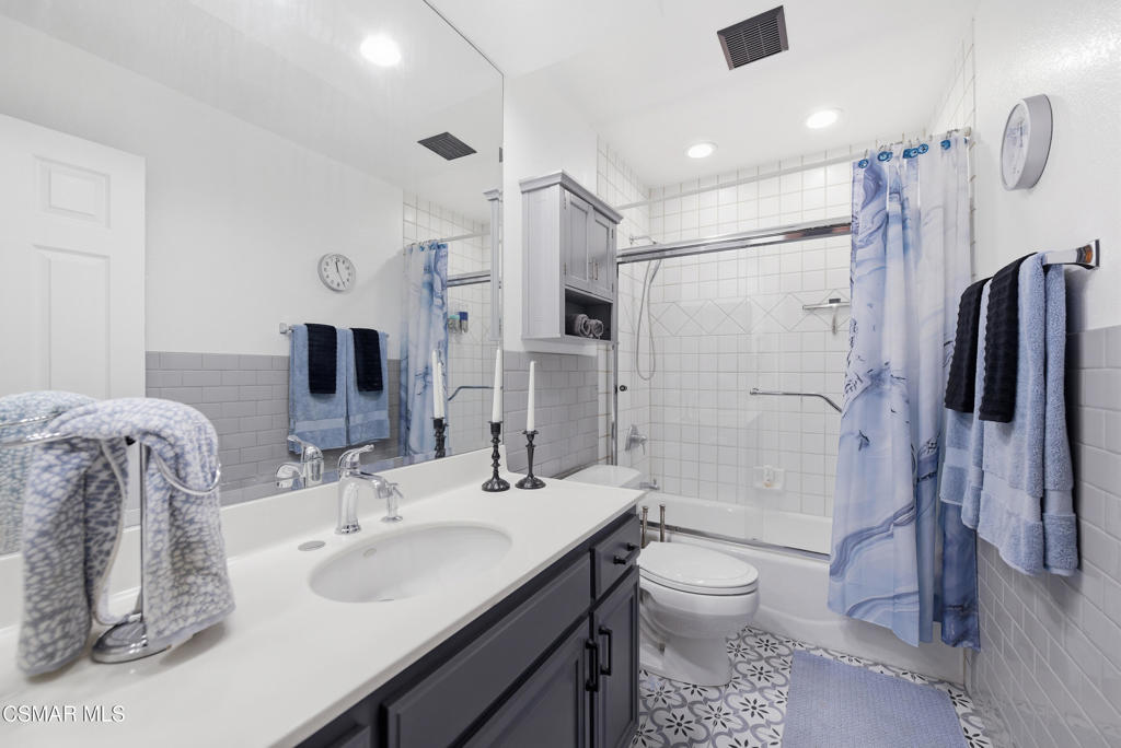 2497 Orangewood Place Simi Valley, CA 93065 - Photo 27 of 42 a bathroom with a double vanity sink toilet and shower