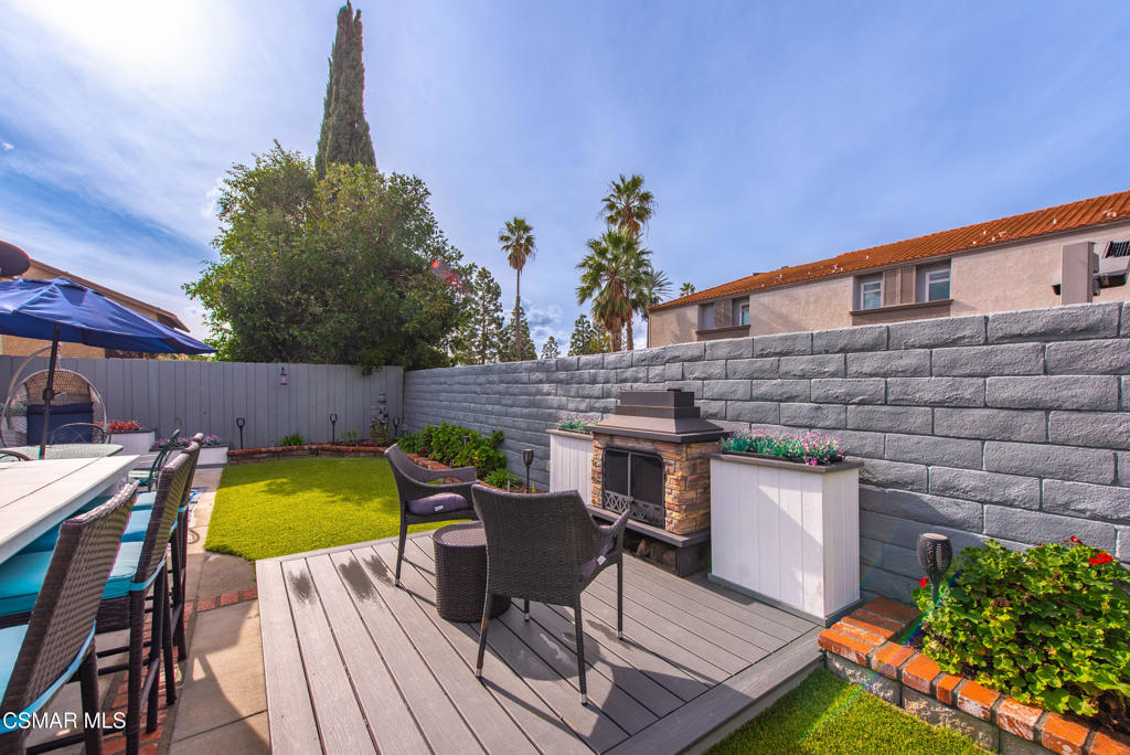 2497 Orangewood Place Simi Valley, CA 93065 - Photo 31 of 42 a view of deck with table and chairs with wooden floor and plants