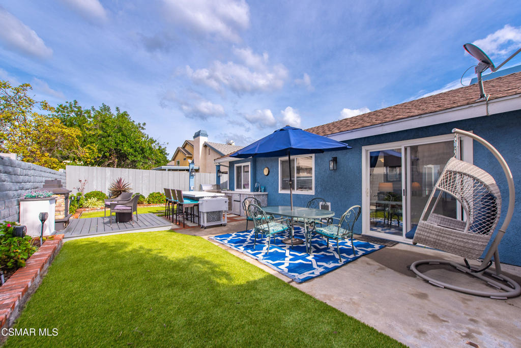 2497 Orangewood Place Simi Valley, CA 93065 - Photo 32 of 42 a view of a patio with table and chairs a barbeque with wooden fence